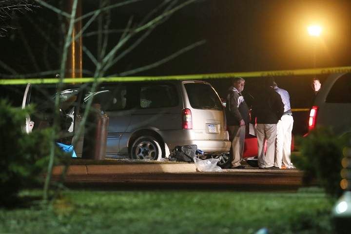 Police investigate the scene early Sunday, Feb. 21, 2016, where people were shot in vehicles outside a Cracker Barrel restaurant.