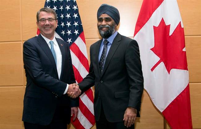 U.S. Secretary of Defense Ash Carter, left, shakes hands with Canadian Defence Minister Harjit Singh Sajjan prior to a bilateral meeting at NATO headquarters in Brussels on Wednesday, Feb. 10, 2016.