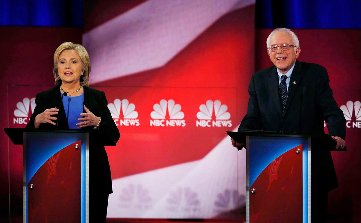 Democratic presidential candidate, Hillary Clinton gestures during the NBC, YouTube Democratic presidential debate at the Gaillard Center, Sunday, Jan. 17, 2016, in Charleston, S.C. To the right is Democratic presidential candidate, Sen. Bernie Sanders, I-Vt. 