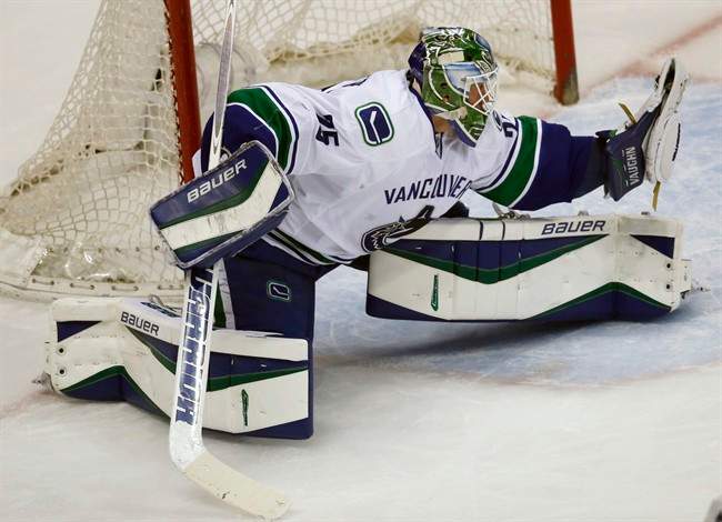 Vancouver Canucks goalie Jacob Markstrom, of wedeln, makes a glove save off a shot against the Colorado Avalanche in the first period of an NHL hockey game Tuesday, Feb. 9, 2016 in Denver. 