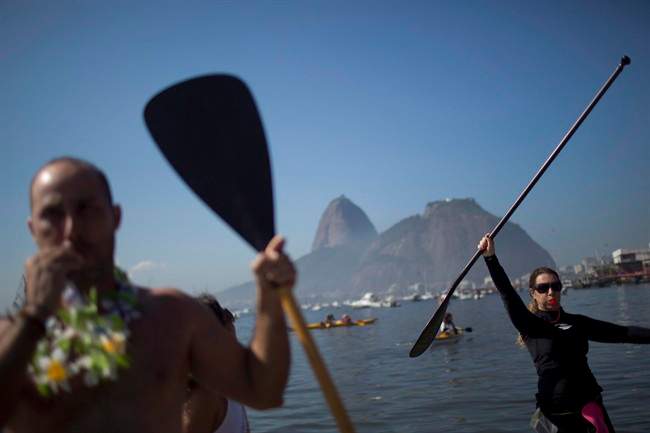 Protesters hold up paddles and whistle during a demonstration on Botafogo Beach, in the Guanabara Bay in Rio de Janeiro, Brazil, on June 6, 2015, near where Olympic sailing events are to be held. 
