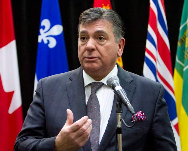 Ontario Finance Minister Charles Sousa talks to reporters before the start of a meeting with Federal Finance Minister Bill Morneau and his provincial and territorial counterparts, in Ottawa, on Monday, Dec. 21, 2015. Ontario's Liberal government will introduce the 2016 provincial budget on Feb. 25, two months earlier than last year's fiscal plan was announced.