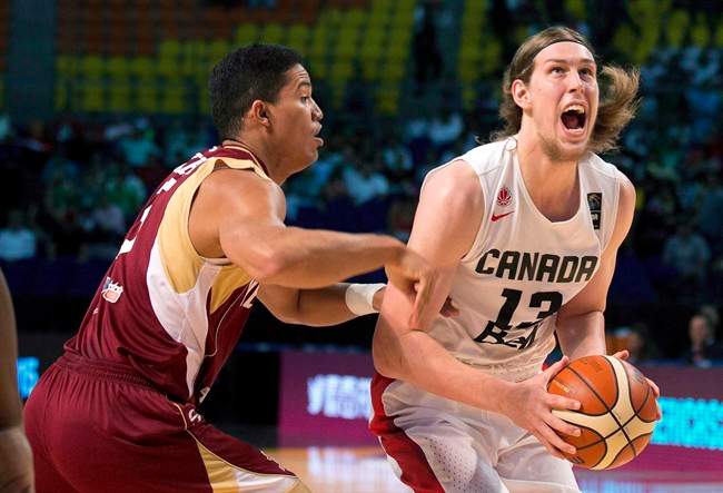 Canada's Kelly Olynyk, right, looks to shoot under pressure from Venezuela's Windi Graterol, during a FIBA Americas Championship basketball game in Mexico City, Friday, Sept. 11, 2015.