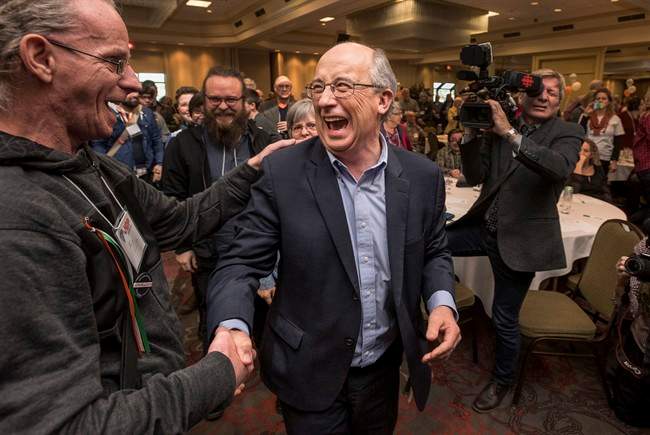 Gary Burrill, centre, celebrates with supporters following his election as leader of the Nova Scotia New Democratic Party in February. Burrill doesn't have a seat in the legislature and says he won't run until the premier calls a general election.
