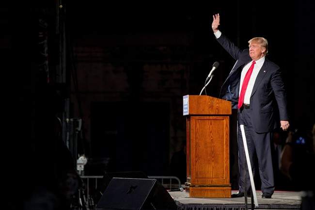 Republican presidential candidate Donald Trump waves after speaking during a rally at Millington Regional Airport in Millington, Tenn., Saturday, Feb. 27, 2016. (AP Photo/Andrew Harnik)