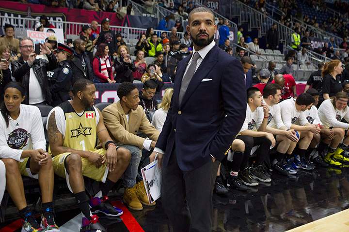 Drake stands in front of Team Canada's bench before the start of the NBA celebrity all-star game in Toronto on Friday February 12, 2016. 