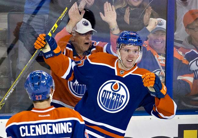 Edmonton Oilers' Connor McDavid (97) and Adam Clendening (27) celebrate McDavid's goal against the Columbus Blue Jackets during second period NHL action in Edmonton, Alta., on Tuesday February 2, 2016. 
