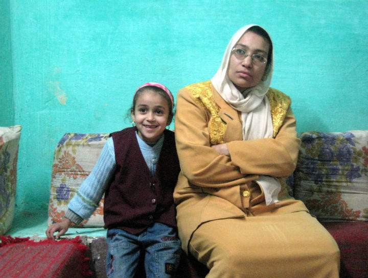 Maha Mohammed, right, and her daughter Rehab, left, listen to workers from a local rights group, not pictured, who explain the dangers of female circumcision during a visit to Mohammed's home in the Egyptian village of Sultan Zawyit on Dec. 5, 2015. (File photo).