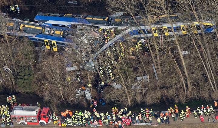 Firefighters and emergency doctors work at the site of a train accident near Bad Aibling, southern Germany, on February 9, 2016.