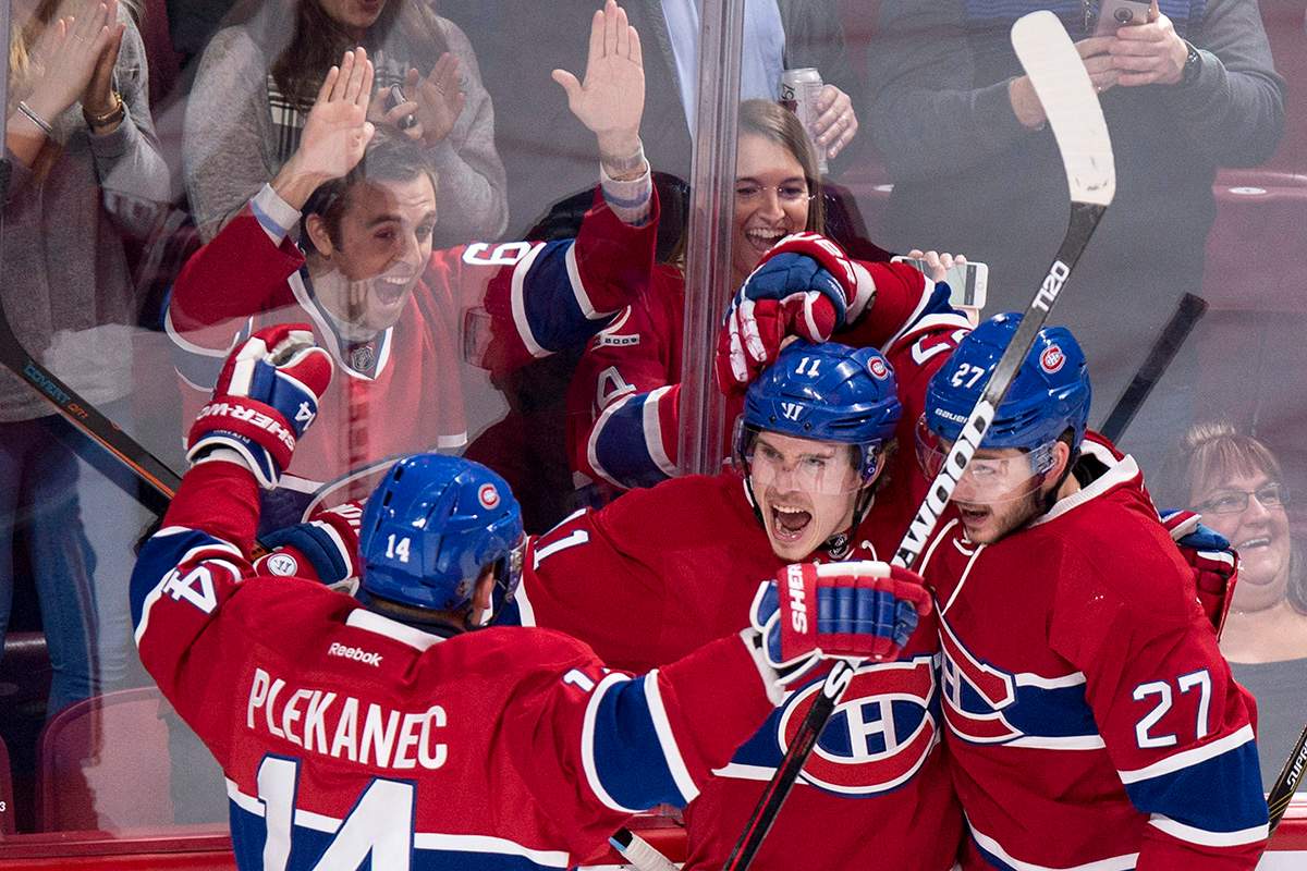 Montreal Canadiens' Brendan Gallagher celebrates his goal against the Tampa Bay Lightning with teammates Tomas Plekanec, left, and Alex Galchenyuk, right, during first period NHL hockey action Tuesday, February 9, 2016 in Montreal.