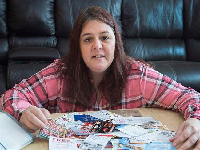 Dana Calder, who runs the website Coupon Nannie, displays coupons in her rural home in North River, N.S. on Thursday, Jan. 27, 2016. 