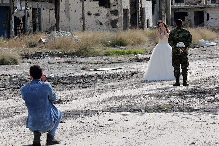 IN PHOTOS: Newlywed Syrian couple pose for wedding pictures amid ruins of war-ravaged city of Homs - image