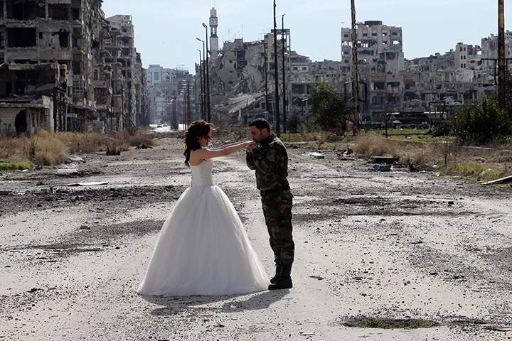 IN PHOTOS: Newlywed Syrian couple pose for wedding pictures amid ruins of war-ravaged city of Homs - image