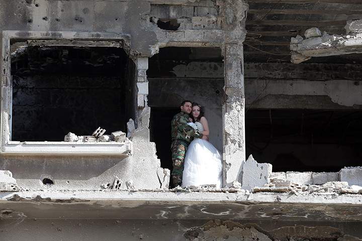IN PHOTOS: Newlywed Syrian couple pose for wedding pictures amid ruins of war-ravaged city of Homs - image