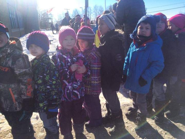 Children walk back to their school in La Loche, more than a month after the tragic school shooting.