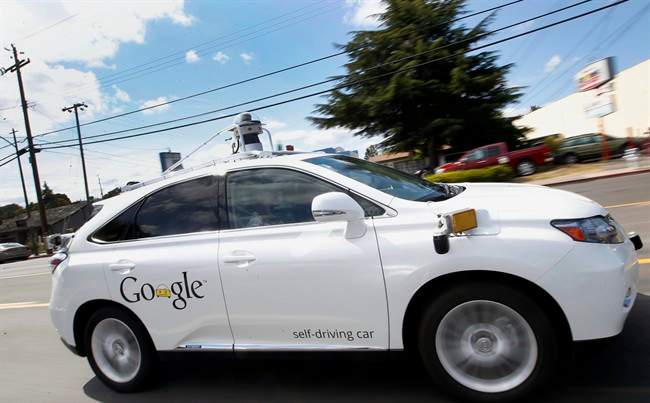 In this May 13, 2015, file photo, Google's self-driving Lexus car drives along street during a demonstration at Google campus in Mountain View, Calif.