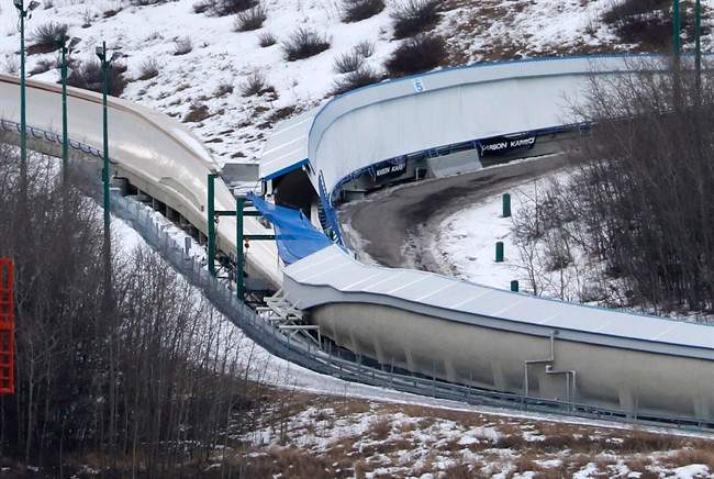 A tarp covers the intersection of the bobsled and luge tracks at Canada Olympic Park in Calgary, Alta., on Saturday, Feb. 6, 2016. An after-hours visit to a Calgary luge-bobsled track early Saturday resulted in the deaths of two young men and injuries to six others. Calgary police say emergency crews were called to the WinSport facility in northwest Calgary at 1:30 a.m. after a report of several injured people on a closed track. 