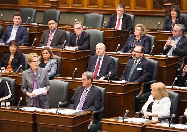 Ontario Premier Kathleen Wynne, bottom left, speaks during question period at Queen's Park in Toronto on Monday, February 22, 2016. THE CANADIAN PRESS/Nathan Denette.