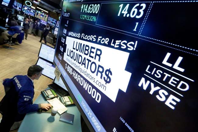 In this Monday, Feb. 1, 2016, file photo, specialist Anthony Rinaldi works on the trading floor of the New York Stock Exchange, adjacent to the post that handles Lumber Liquidators. 