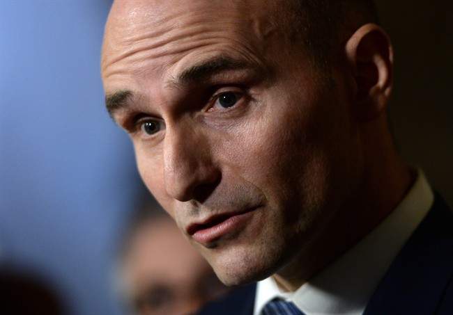 Jean-Yves Duclos, Minister of Families, Children and Social Development, speaks to reporters in the foyer of the House of Commons on Parliament Hill in Ottawa on Tuesday, Feb. 2, 2016.