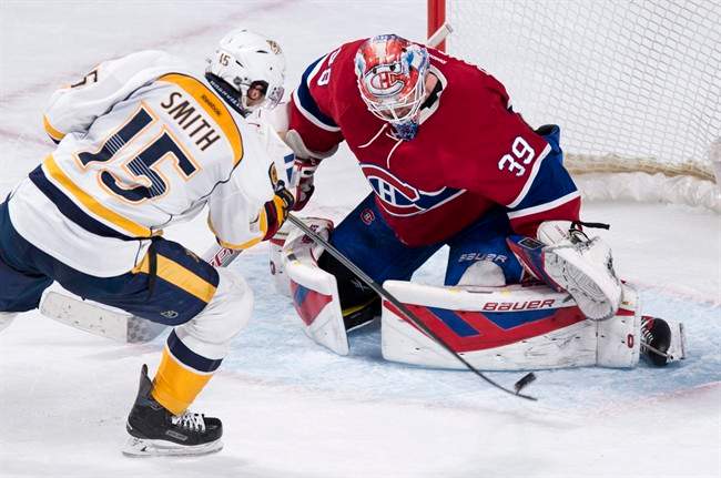 Nashville Predators' Craig Smith (15) scores past Montreal Canadiens goalie Mike Condon during NHL hockey shootout action.