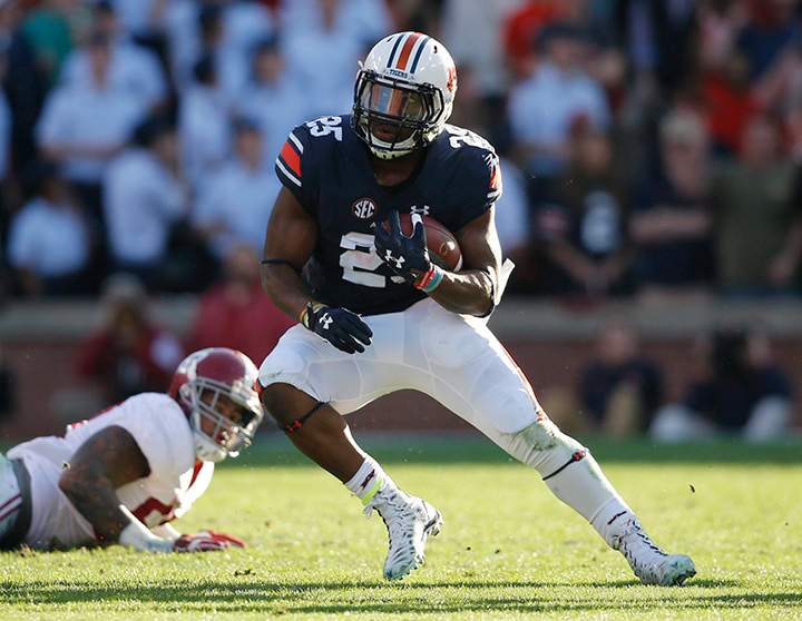 Auburn running back Peyton Barber runs the ball against Alabama defensive lineman D.J. Pettway during an NCAA college football game, Saturday, Nov. 28, 2015, in Auburn, Ala. 