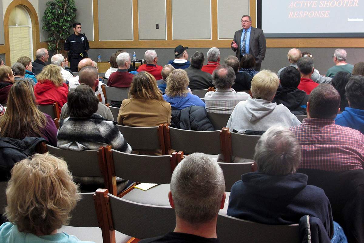 In this Thursday, Jan. 28, 2016 photo, Westerville police chief Joe Morbitzer welcomes community members to a first-ever class about reacting to and surviving an active shooter, while speaking in Westerville, Ohio. 