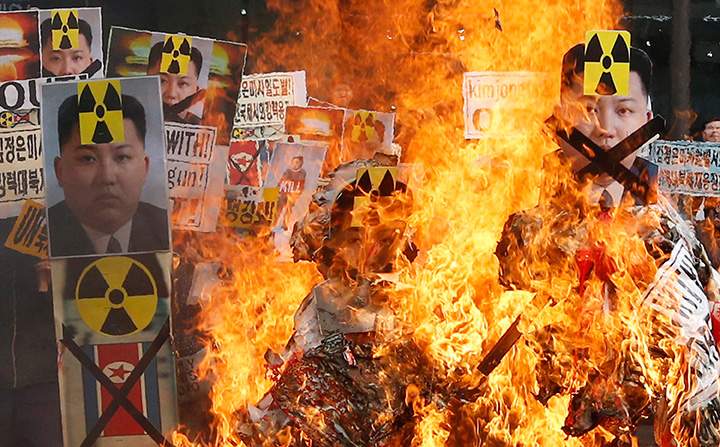 Pictures of North Korean flags, North’s leader Kim Jong Un and missiles are burned by anti-North Korea protesters during a rally in downtown Seoul, South Korea, Thursday, Feb. 11, 2016.