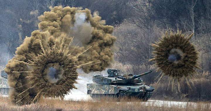 Smoke bombs explode near a South Korean army K-2 tank during a live firing drill at a training field in Yangpyeong, South Korea, on Thursday, Feb. 18, 2016. North Korean leader Kim Jong Un recently ordered preparations for launching “terror” attacks on South Koreans, a top Seoul official said Thursday.