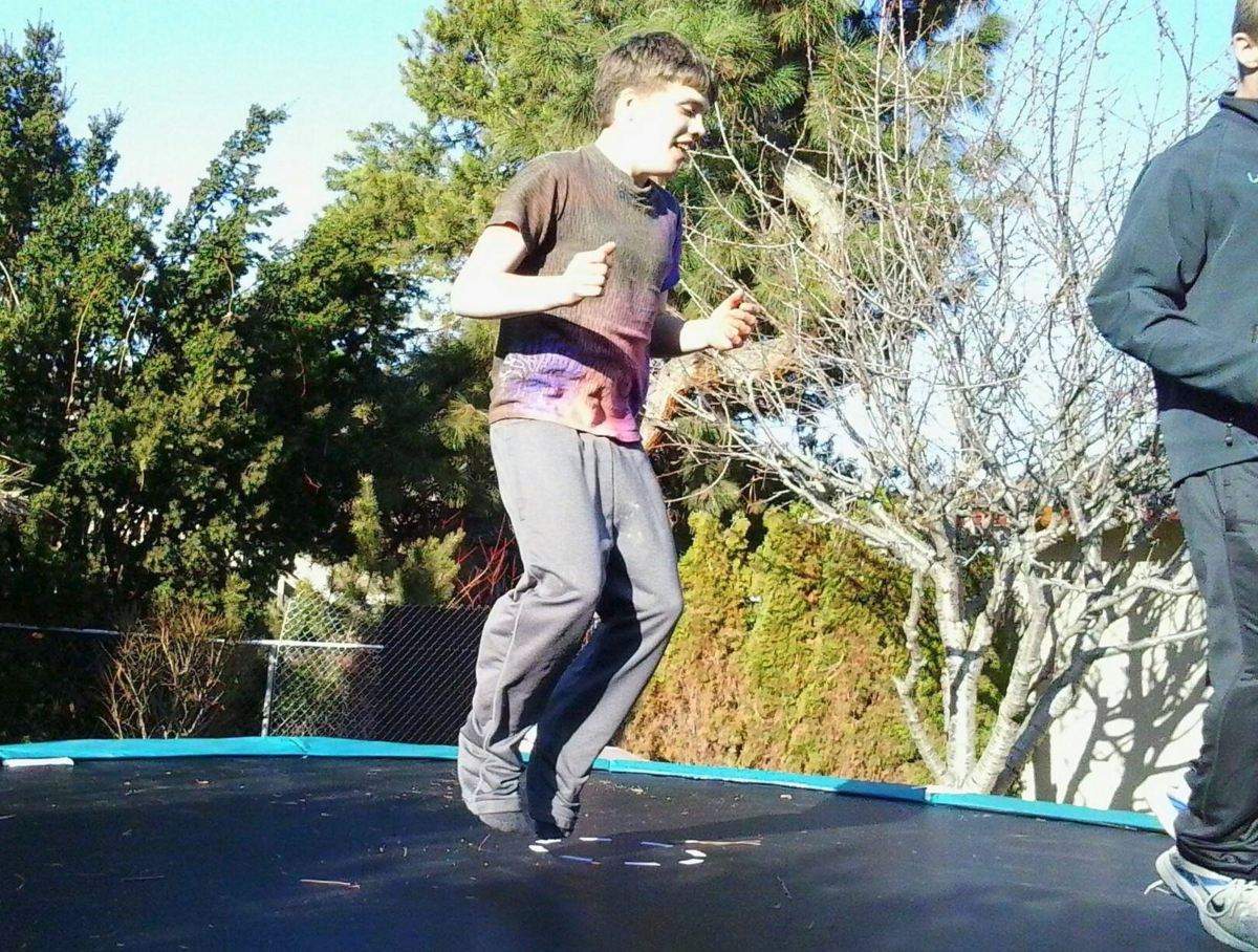 A person jumping on a trampoline.