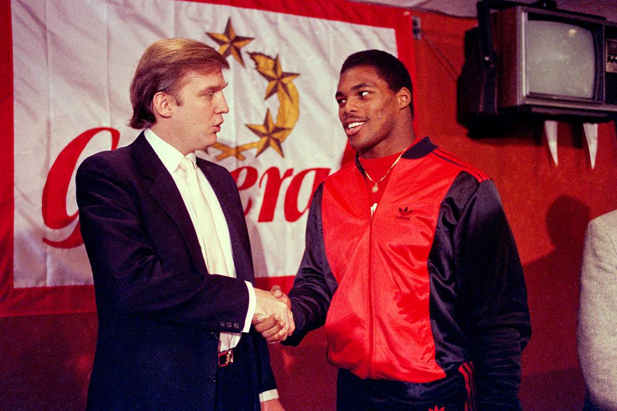  In this March 8, 1984, file photo, Donald Trump shakes hands with Herschel Walker in New York after agreement on a 4-year contract with the New Jersey Generals USFL football team. 