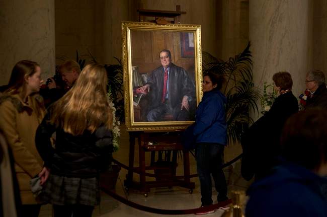 FILE - In this Feb. 19, 2016 file photo, people line up to pay their respect to the late Justice Antonin Scalia in the Great Hall of the Supreme Court in Washington, where Scalia's body lies in repose. A letter from the Supreme Court's doctor said Scalia suffered from coronary artery disease, obesity and diabetes, among other ailments that probably contributed to the justice's sudden death.