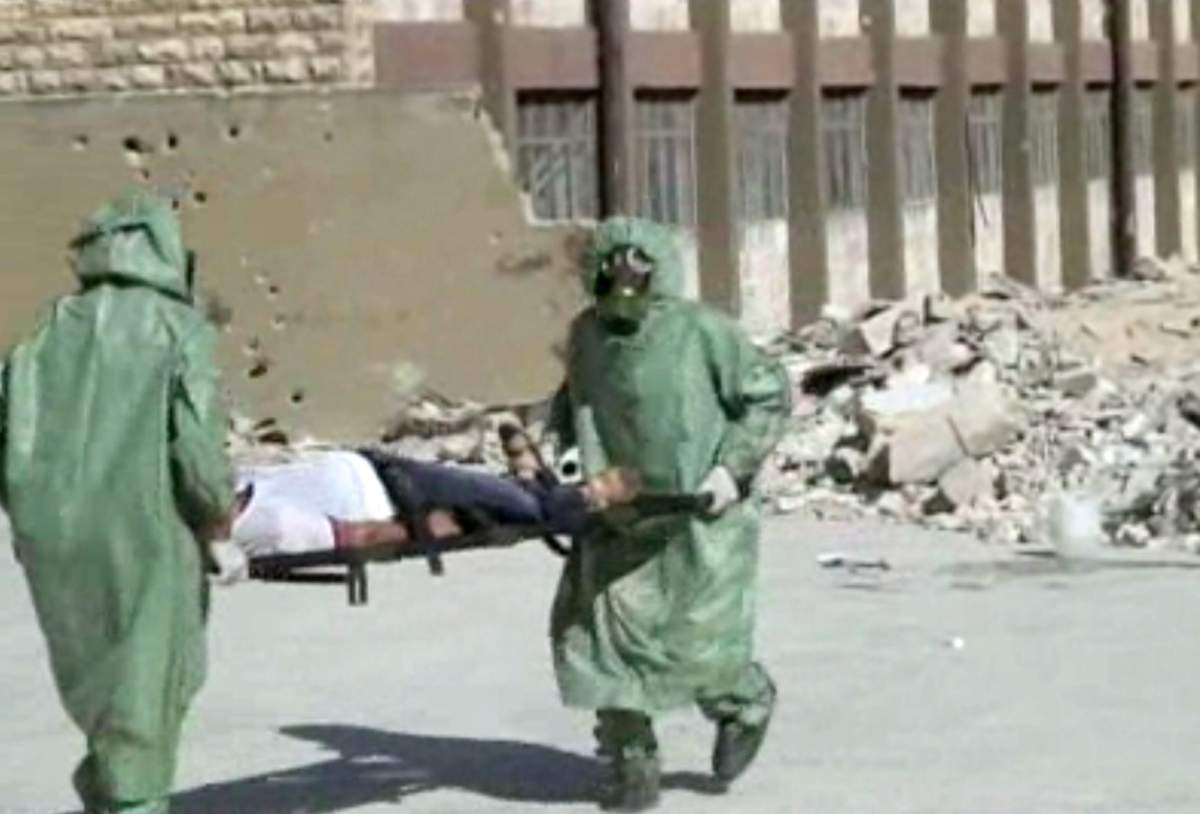 This image made from an AP video posted on Wednesday, Sept. 18, 2013 shows shows Syrians in protective suits and gas masks conducting a drill on how to treat casualties of a chemical weapons attack in Aleppo, Syria. The Islamic State group is aggressively pursuing development of chemical weapons, setting up a branch dedicated to research and experiments with the help of scientists from Iraq, Syria and elsewhere in the region, according to Iraqi and U.S. intelligence officials. 