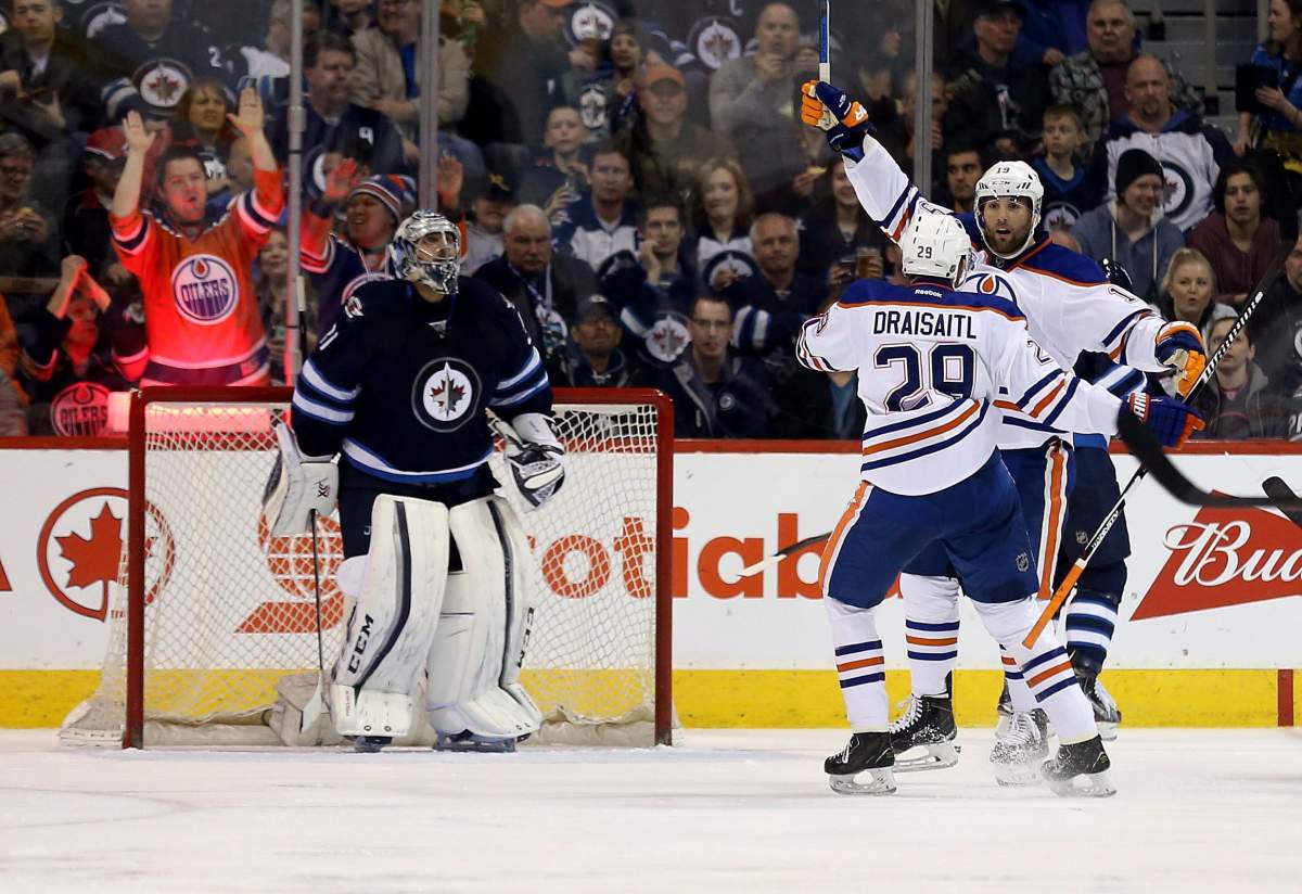 Edmonton Oilers' Leon Draisaitl (29) celebrates with teammate Patrick Maroon (19) after Maroon scored on Winnipeg Jets' goalie Ondrej Pavelec (31) during second period NHL hockey action, in Winnipeg on Sunday, Mar. 6, 2016. THE CANADIAN PRESS/Trevor Hagan.