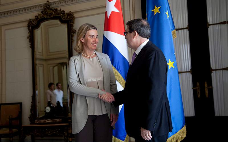 European Union Foreign Policy chief Federica Mogherini shakes hands with Cuban Foreign Minister Bruno Rodriguez, before a meeting, where an agreement was signed to establish normal relations, in Havana, Cuba, Friday, March 11, 2016. 