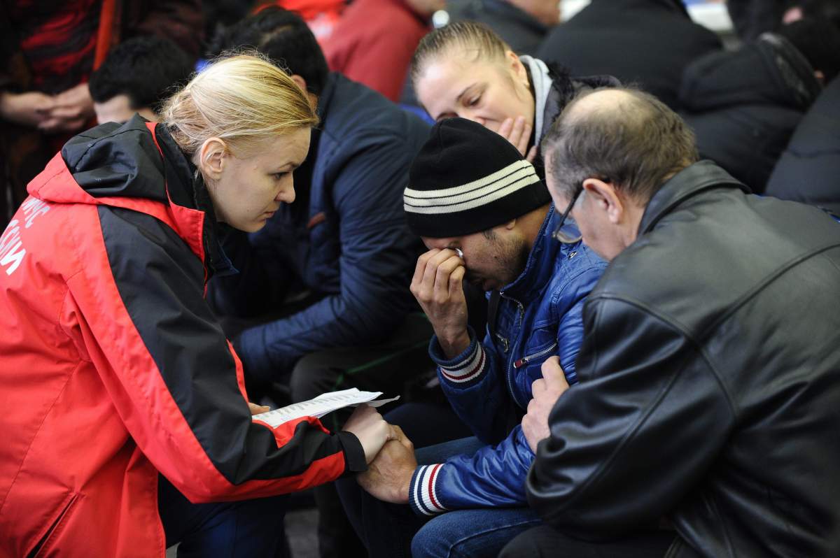 A Russian Emergency Situations Ministry employee, left, tries to comfort a relative of the plane crash victims at the Rostov-on-Don airport, about 950 kilometers (600 miles) south of Moscow, Russia Saturday, March 19, 2016. An airliner coming from Dubai crashed early Saturday while landing in the southern Russian city of Rostov-on-Don, Russias Emergencies Ministry said. (AP Photo)