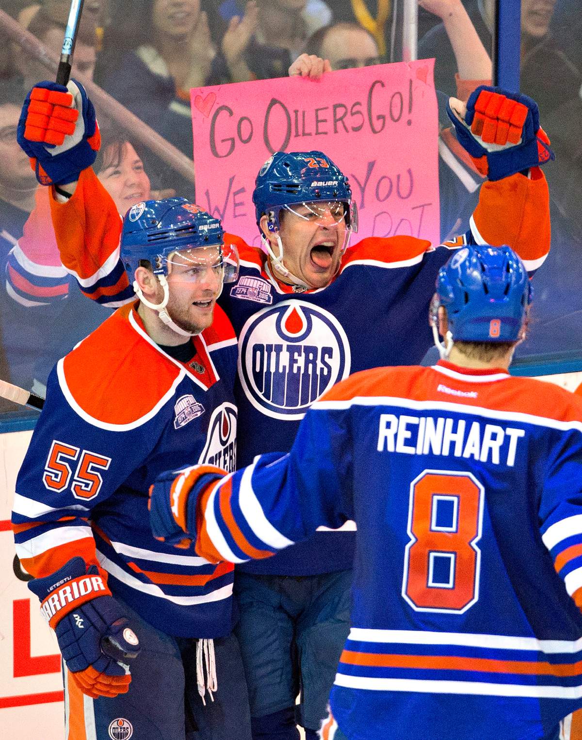Edmonton Oilers' Mark Letestu (55), Matt Hendricks (23) and Griffin Reinhart (8) celebrate a goal against the Colorado Avalanche during third period NHL action in Edmonton, Alta., on Sunday March 20, 2016. 