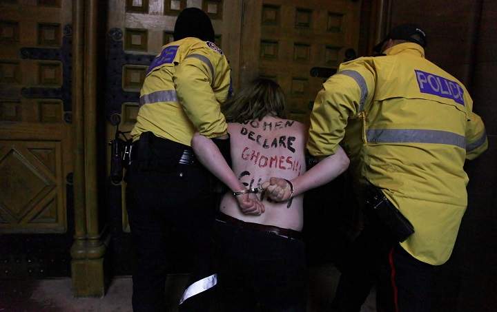 Topless Ghomeshi protester sent by group famous for half-naked media stunts - image