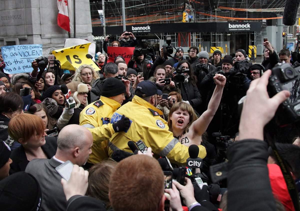 Topless Ghomeshi protester sent by group famous for half-naked media stunts - image