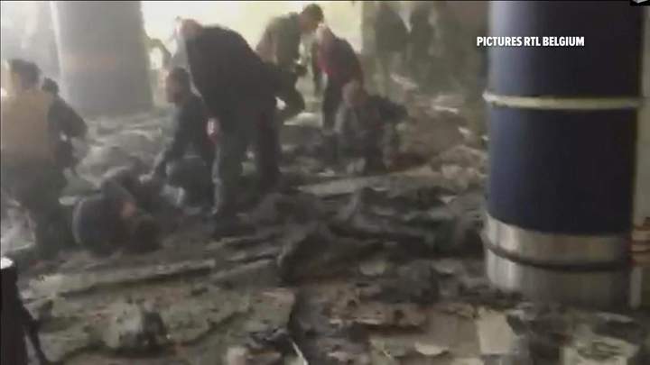 Shortly after the explosion, people receive treatment in the debris-strewn terminal at Brussels Airport.