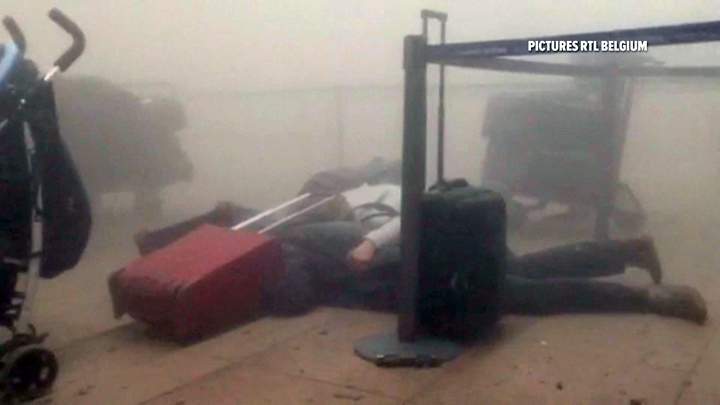 In this still image taken from video from RTL Belgium, travellers lie on the floor at Brussels Airport.