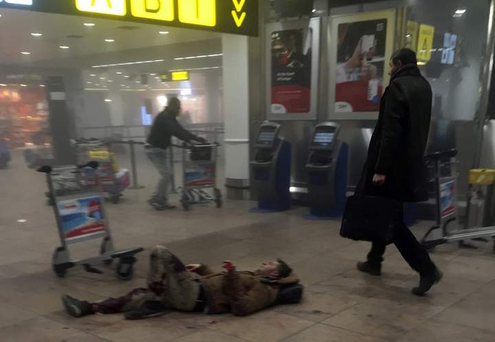 An injured man lies on the floor in Brussels Airport in Belgium after explosions rocked the terminal on Tuesday.