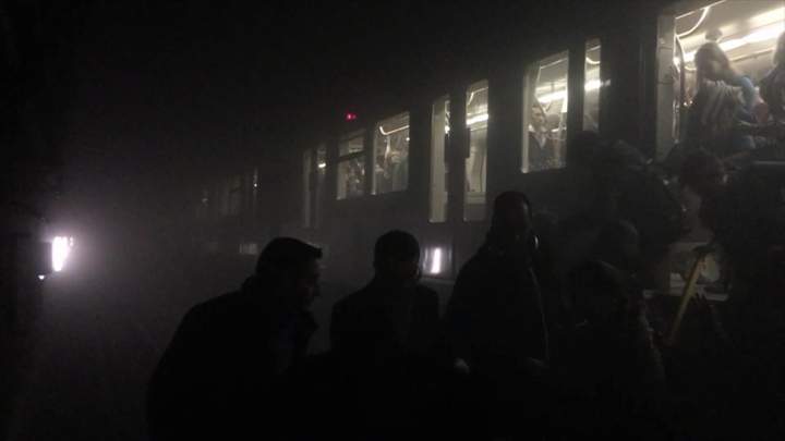 Passengers are evacuated from a subway car after explosions in a station in Brussels.