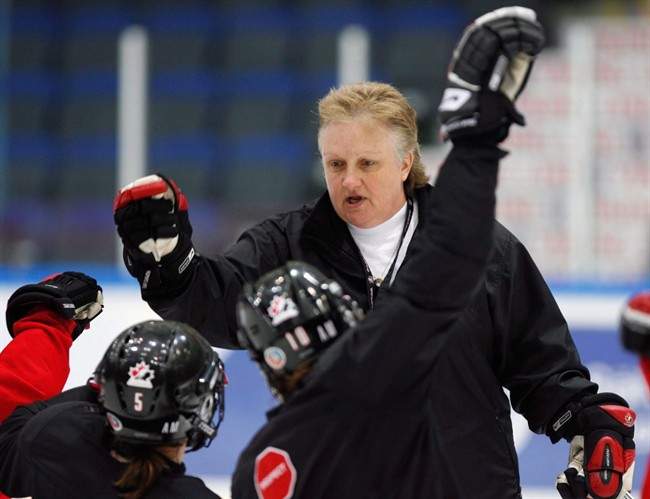 Team Canada head coach Melody Davidson gives high-fives to players at the end of practice at the World Women Hockey Championship Thursday, April 9, 2009 in Hameenlinna, Finland. 