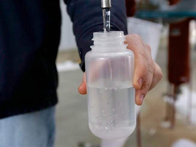 In this photo from Jan. 6, 2015, Ryan Brock fills a sample bottle with ethanol produced at the Green Plains ethanol plant in Shenandoah, Iowa. 