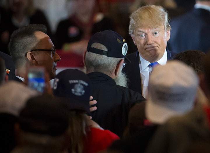 Republican presidential candidate Donald Trump reacts as veteran Keith Maupin asks the candidate to clarify comments he made about Arizona Sen. John McCain during a campaign stop at the Savannah Center, Sunday, March 13, 2016, in West Chester, Ohio. 