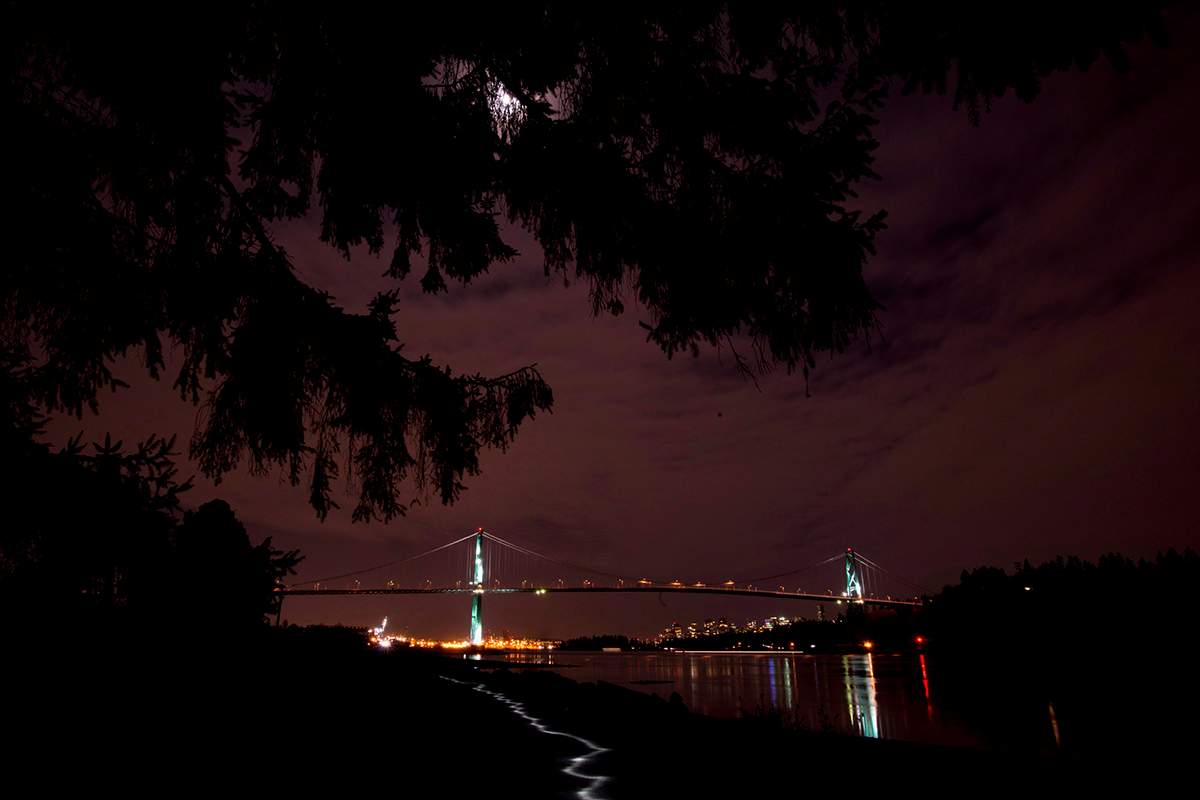 The lights on the Lions Gate bridge are off during Earth Hour as seen from West Vancouver, B.C. Saturday, March, 23, 2013. 