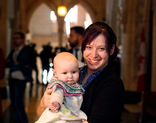 NDP MP Christine Moore holds her daughter Daphnee just outside the House of Commons in March 2016.