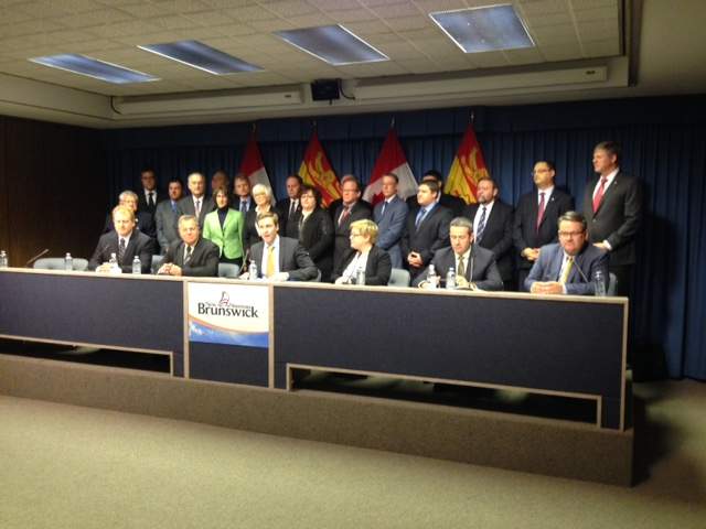 Premier Brian Gallant is surrounded by members of the Liberal caucus as he announces the details of the Education and New Economy Fund.