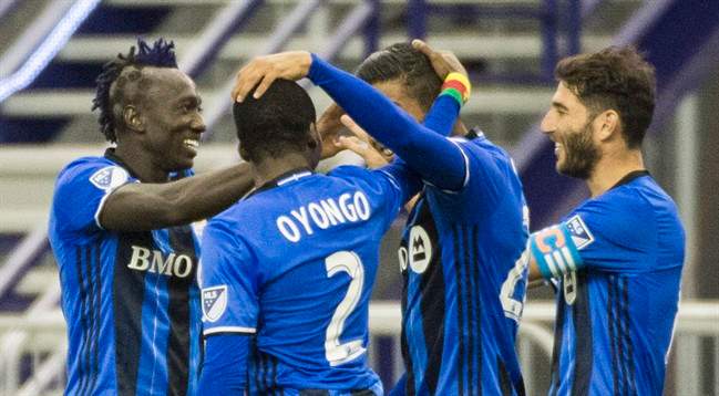 Montreal Impact's Dominic Oduro, left, celebrates with teammates after scoring against the New York Red Bulls during second half MLS soccer action in Montreal Saturday, March 12, 2016.